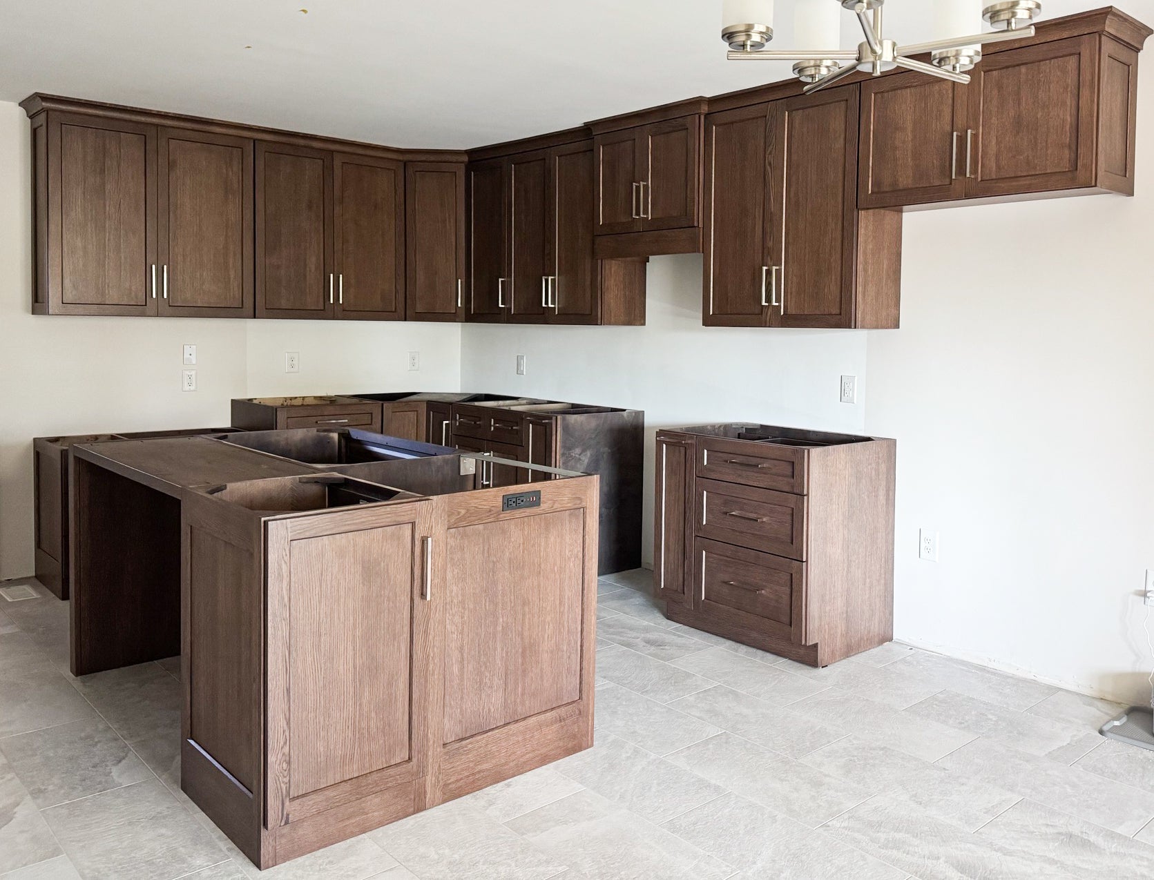 The kitchen features new custom oak wood cabinets in a clean modern style.