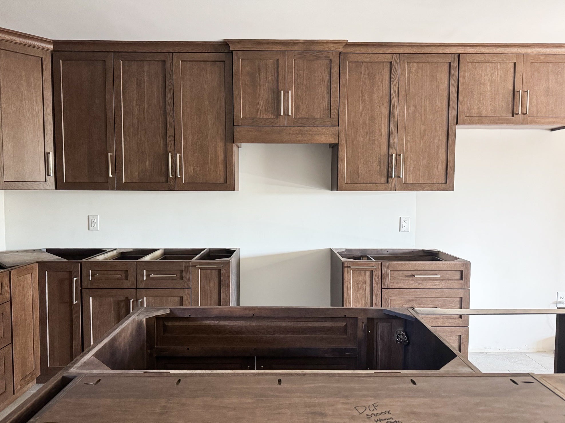 The custom kitchen view shows warm wood toned cabinets in a clean, modern style.